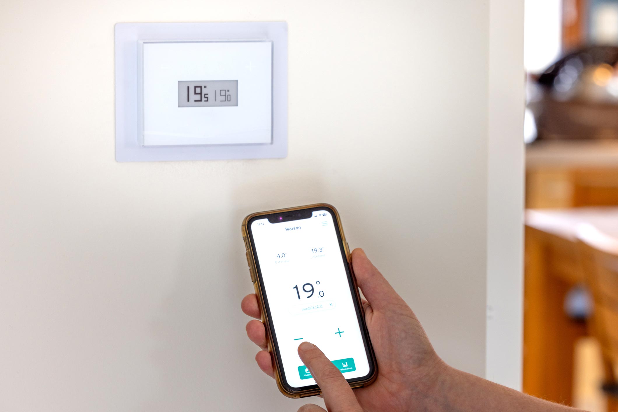image représentant une main avec un telephone pour controler un chaffage en domotique