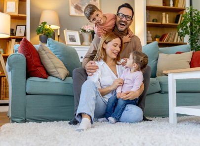 image d'une famille qui rigole dans le salon