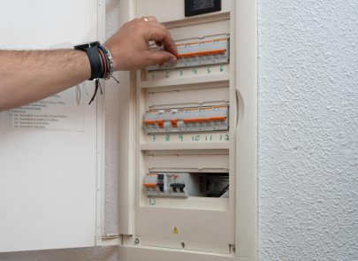 image d'une main intervenant sur un tableau électrique
